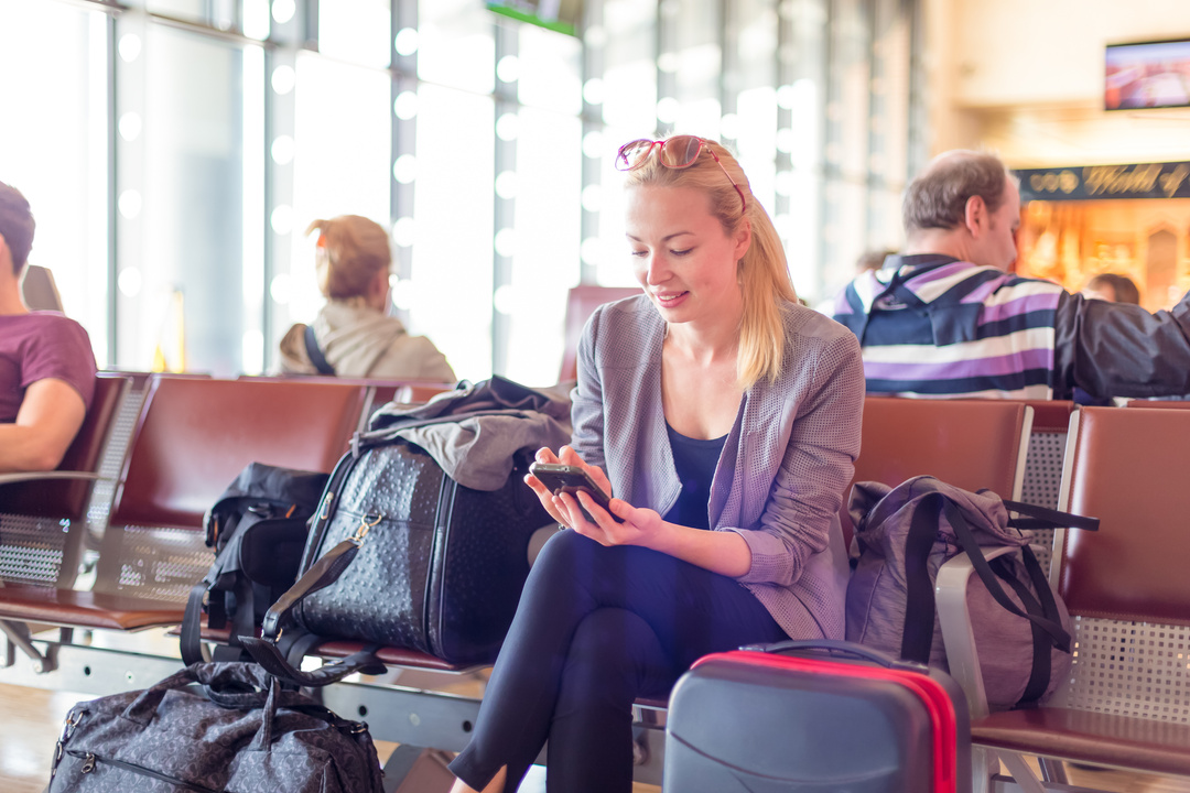 Female Traveler Using Cell Phone 